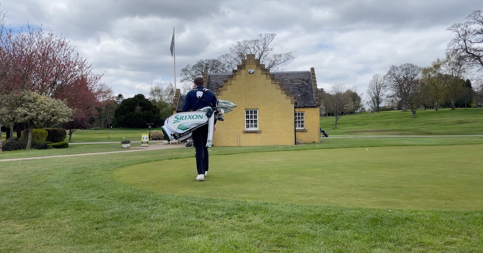 andy carrying golf bag